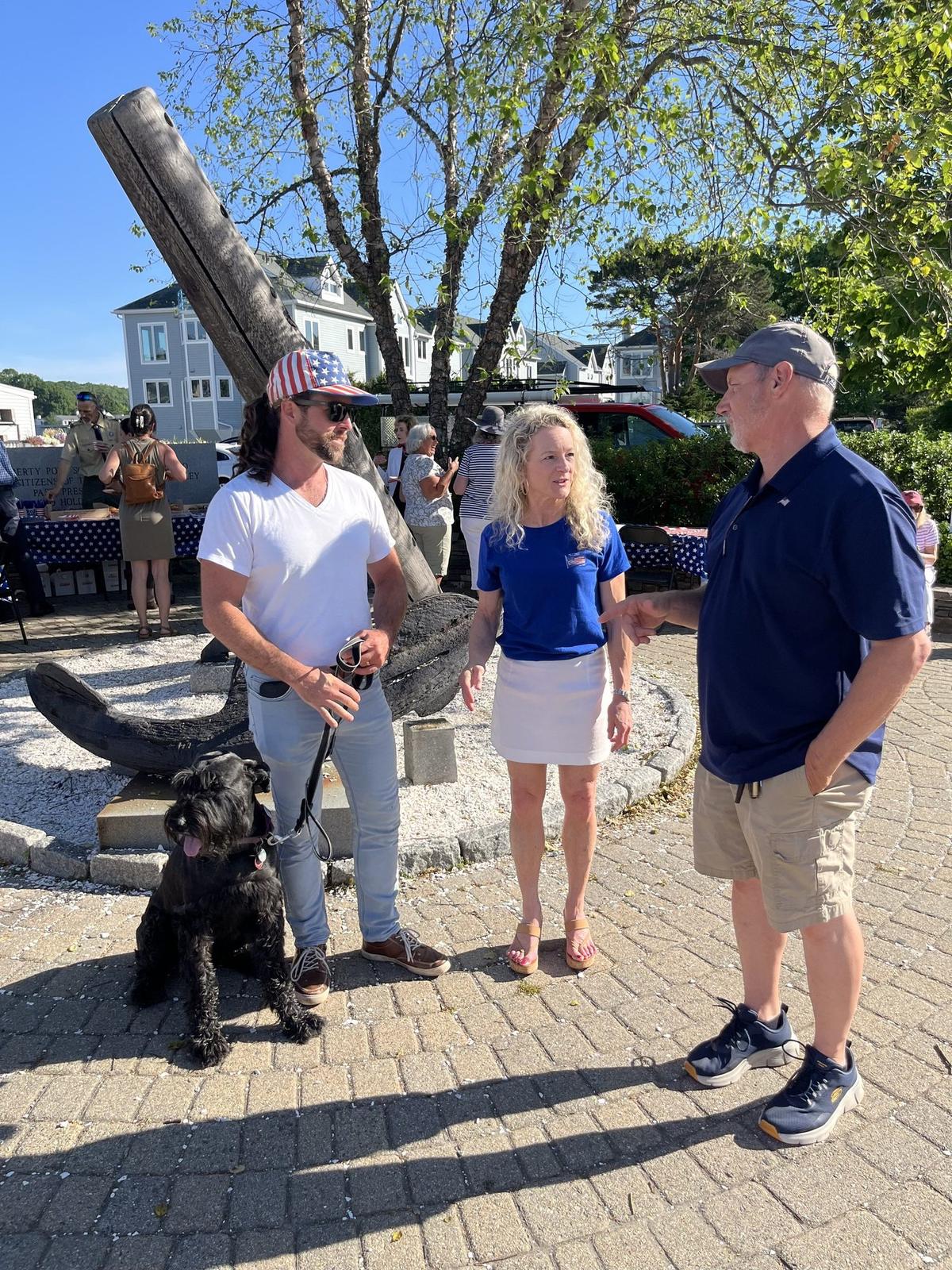 Thaler Hefel talking with neighbors at a community event