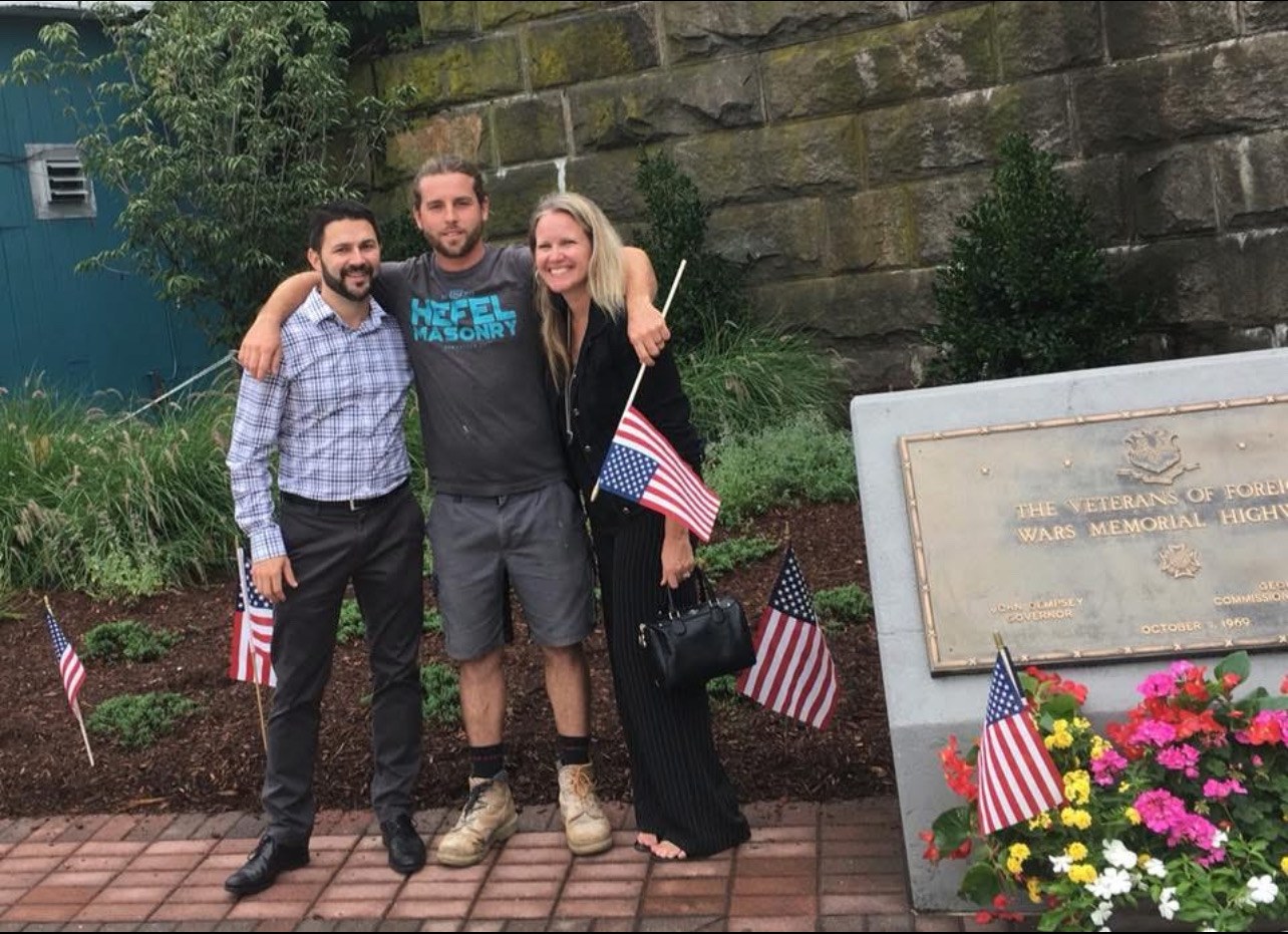 Thaler Hefel with community members at a veterans memorial